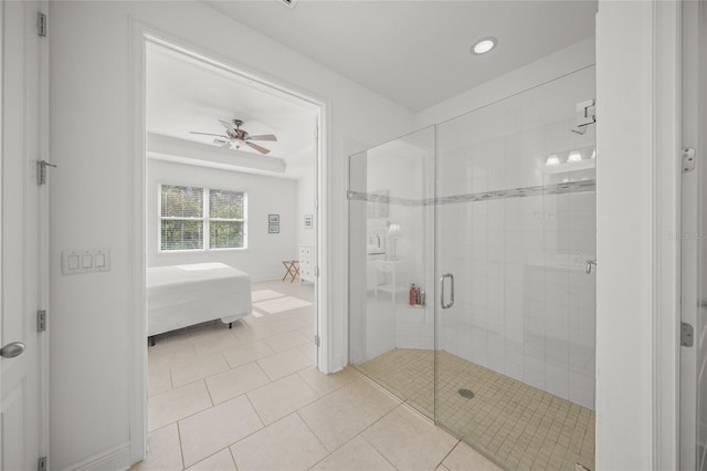 bathroom featuring tile patterned flooring, a shower with door, and ceiling fan