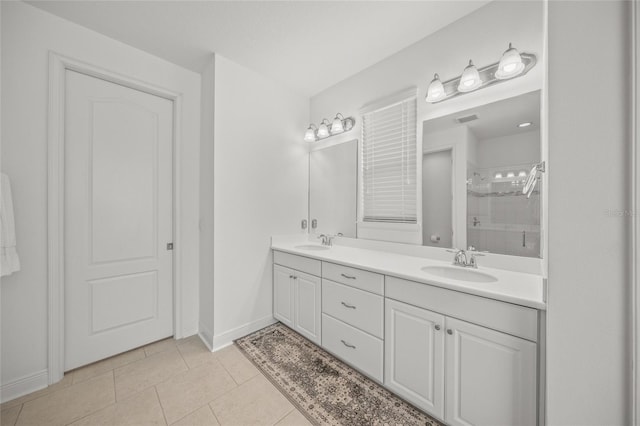 bathroom with tile patterned flooring, vanity, and walk in shower