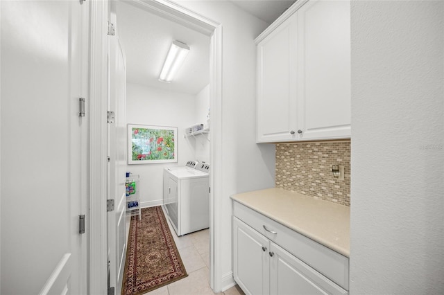 washroom with light tile patterned floors and washer and dryer