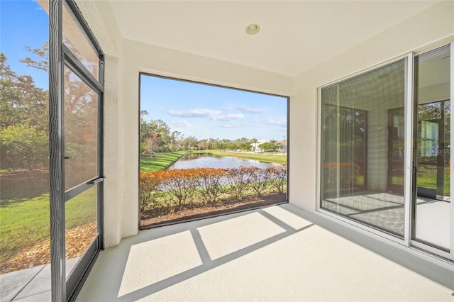 unfurnished sunroom with a water view