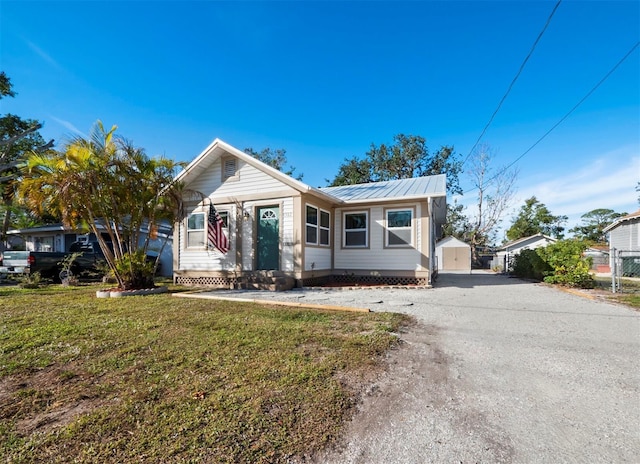 view of front of house with an outbuilding, a garage, and a front yard