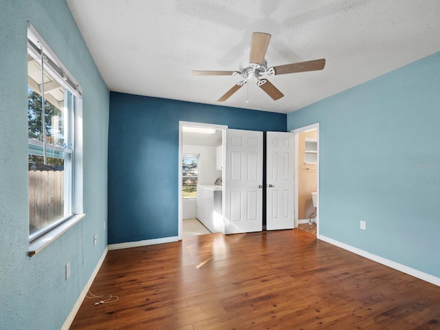 empty room with a textured ceiling, dark hardwood / wood-style floors, and ceiling fan