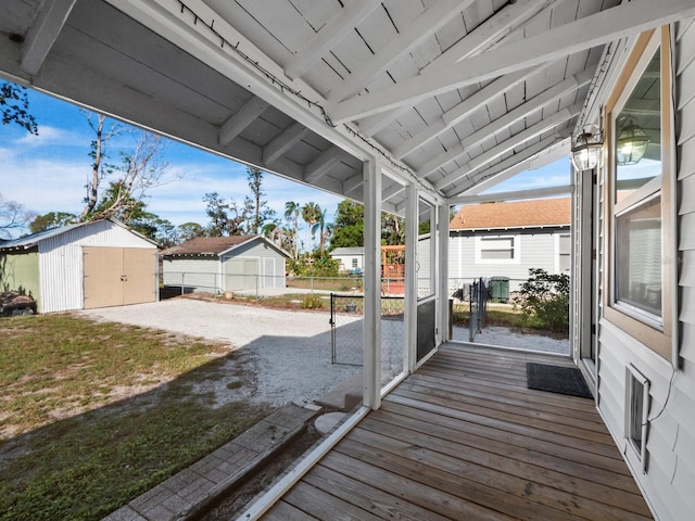 wooden deck featuring a shed