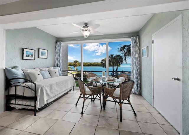 interior space featuring access to exterior, ceiling fan, a water view, and light tile patterned floors