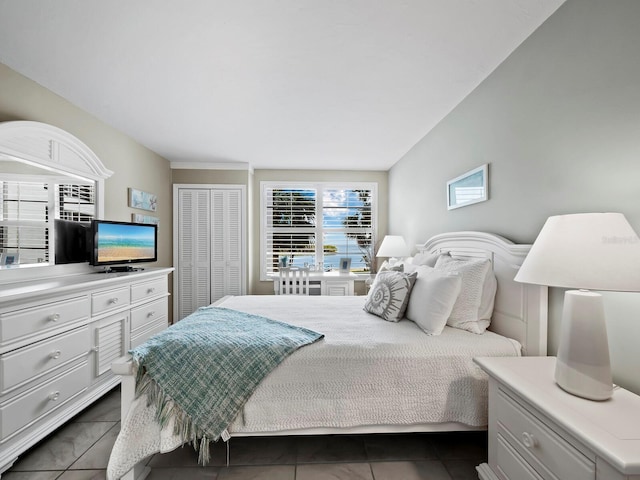 tiled bedroom featuring a closet