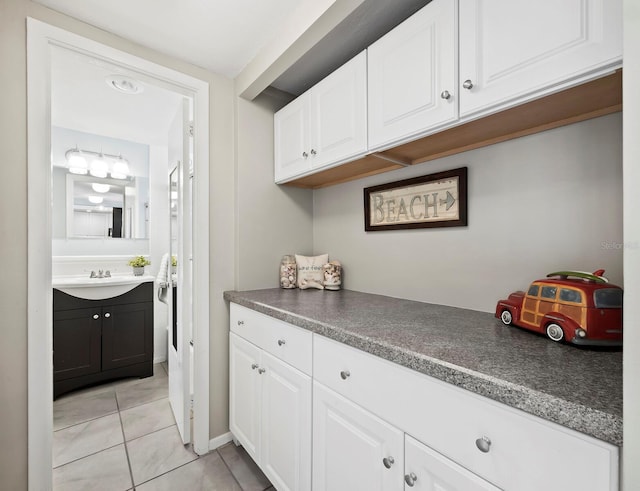 washroom with light tile patterned floors and sink