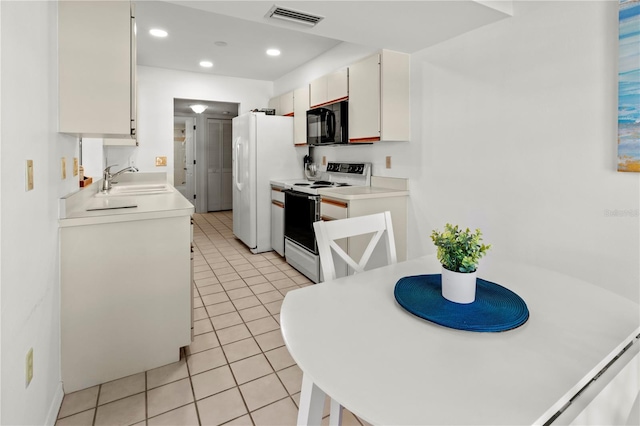 kitchen featuring white cabinetry, light tile patterned flooring, white appliances, and sink