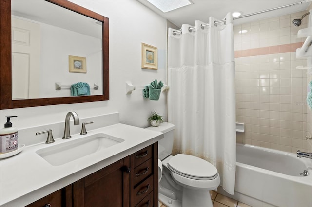 full bathroom featuring vanity, tile patterned floors, a skylight, toilet, and shower / tub combo with curtain