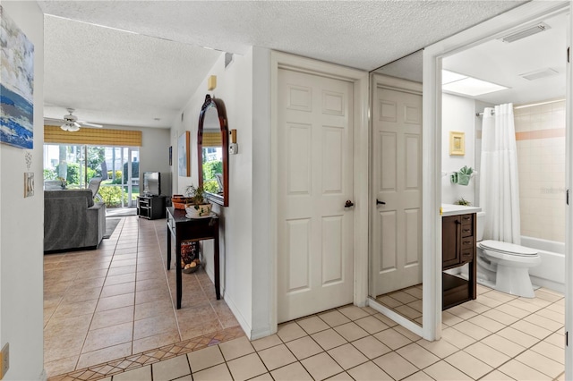 5697 Sheffield Greene Cir Unit 51, Sarasota, FL 34235 - hall featuring light tile patterned floors and a textured ceiling