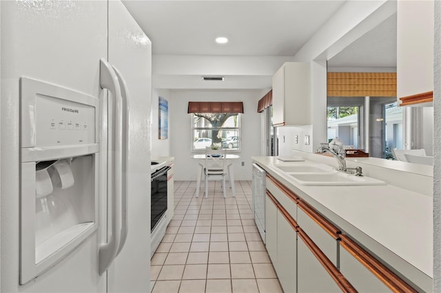 5697 Sheffield Greene Cir Unit 51, Sarasota, FL 34235 - kitchen with white appliances, light tile patterned flooring, plenty of natural light, light countertops, and recessed lighting