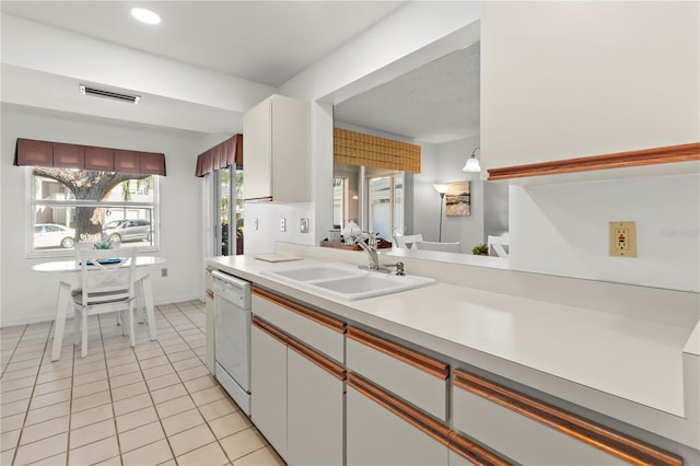 5697 Sheffield Greene Cir Unit 51, Sarasota, FL 34235 - kitchen featuring white dishwasher, light countertops, and light tile patterned flooring