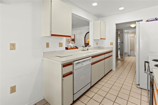 5697 Sheffield Greene Cir Unit 51, Sarasota, FL 34235 - kitchen with white appliances, light countertops, light tile patterned flooring, white cabinets, and recessed lighting