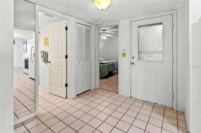 5697 Sheffield Greene Cir Unit 51, Sarasota, FL 34235 - entrance foyer with a textured ceiling, light tile patterned flooring, and ceiling fan
