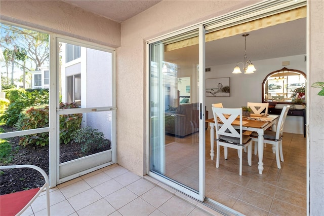 5697 Sheffield Greene Cir Unit 51, Sarasota, FL 34235 - sunroom / solarium featuring a chandelier, outdoor dining space, and healthy amount of natural light