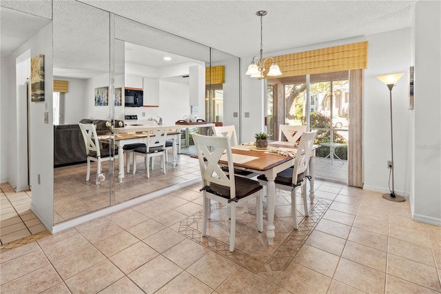 5697 Sheffield Greene Cir Unit 51, Sarasota, FL 34235 - dining area featuring light tile patterned flooring, a chandelier, and a textured ceiling