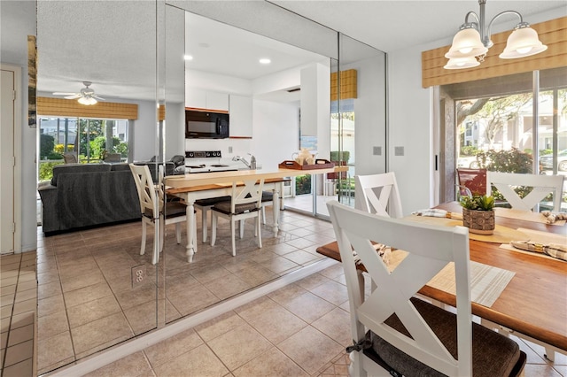 5697 Sheffield Greene Cir Unit 51, Sarasota, FL 34235 - dining area with light tile patterned floors, ceiling fan, recessed lighting, and a chandelier