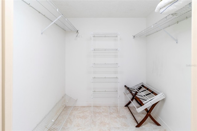 5697 Sheffield Greene Cir Unit 51, Sarasota, FL 34235 - walk in closet with tile patterned flooring