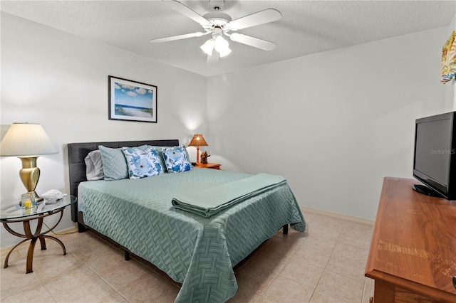 5697 Sheffield Greene Cir Unit 51, Sarasota, FL 34235 - bedroom featuring light tile patterned flooring, a textured ceiling, and a ceiling fan