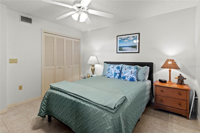 5697 Sheffield Greene Cir Unit 51, Sarasota, FL 34235 - bedroom with a closet, tile patterned floors, a textured ceiling, and ceiling fan