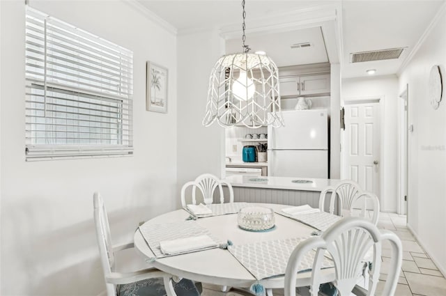 dining room featuring ornamental molding and light tile patterned floors