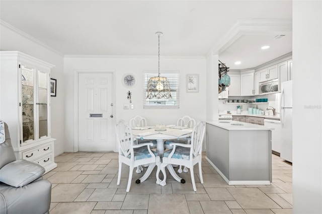 dining area featuring sink and crown molding