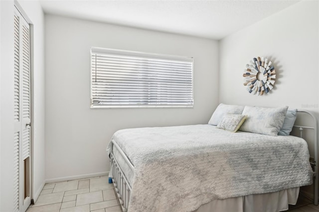 tiled bedroom with a closet