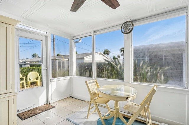 sunroom / solarium featuring ceiling fan