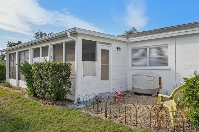 view of side of property featuring a sunroom