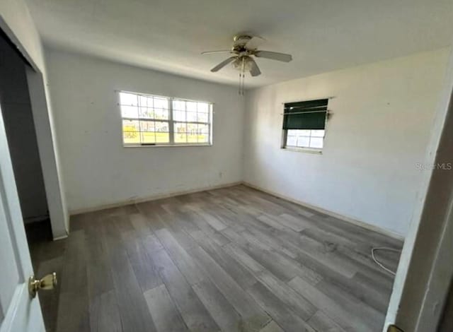 unfurnished bedroom with a closet, ceiling fan, and hardwood / wood-style floors