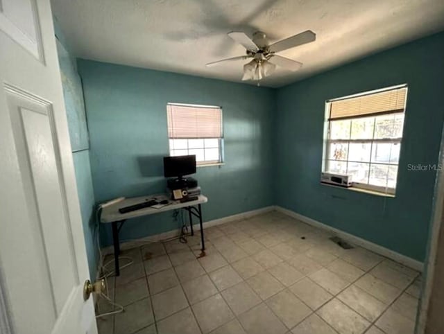 tiled office space featuring ceiling fan