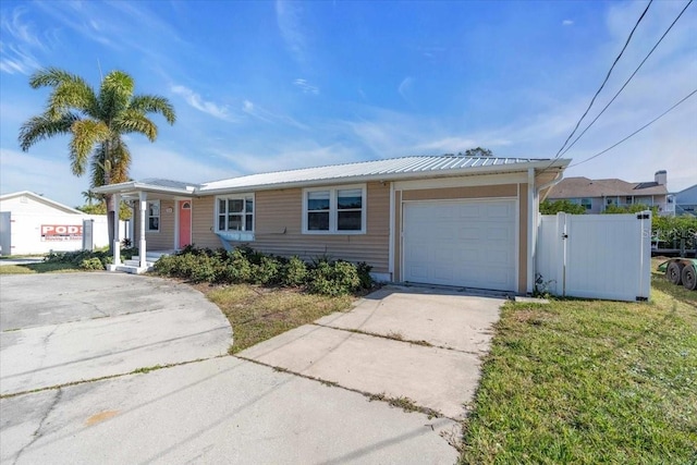 single story home featuring a garage and a front yard