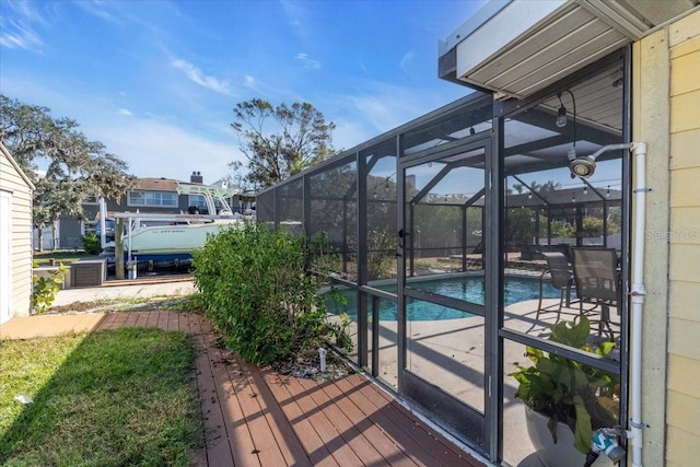 view of swimming pool with glass enclosure and a patio area