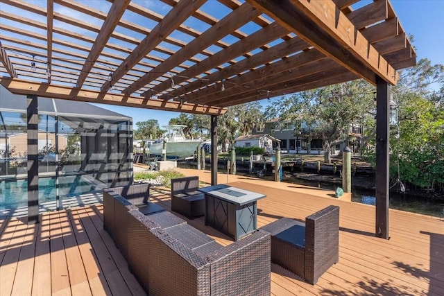 wooden deck featuring a sunroom, a water view, and a pergola