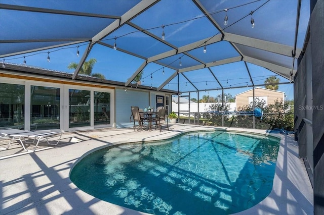 view of pool with a lanai and a patio