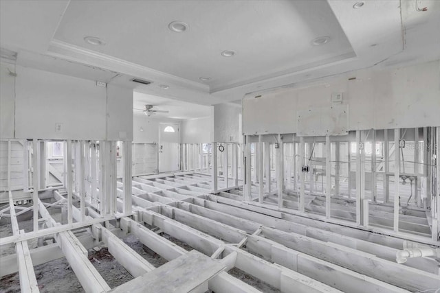 interior space featuring ceiling fan and a tray ceiling