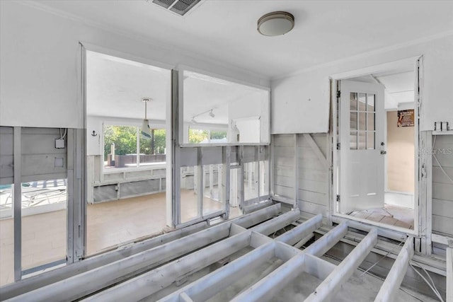 interior space featuring concrete flooring and crown molding