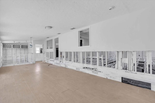 unfurnished room featuring a textured ceiling