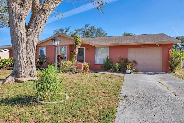 ranch-style home with a garage and a front yard