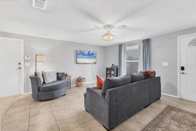 tiled living room with ceiling fan and a textured ceiling