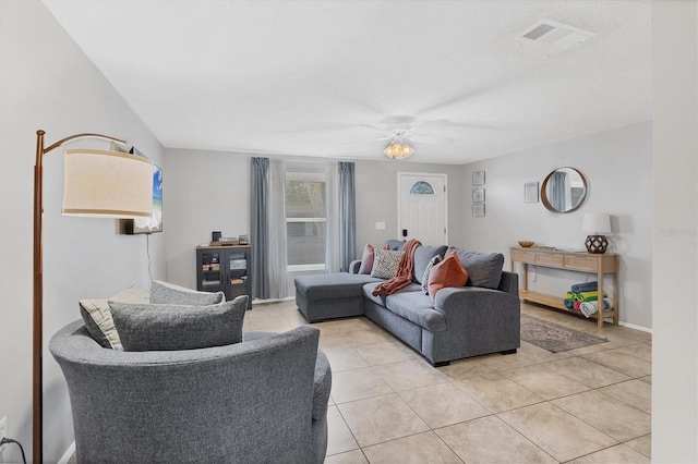 living room featuring ceiling fan and light tile patterned floors