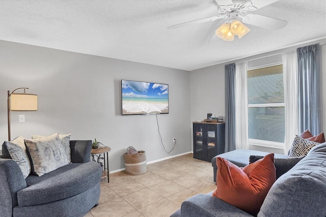 tiled living room featuring a textured ceiling and ceiling fan