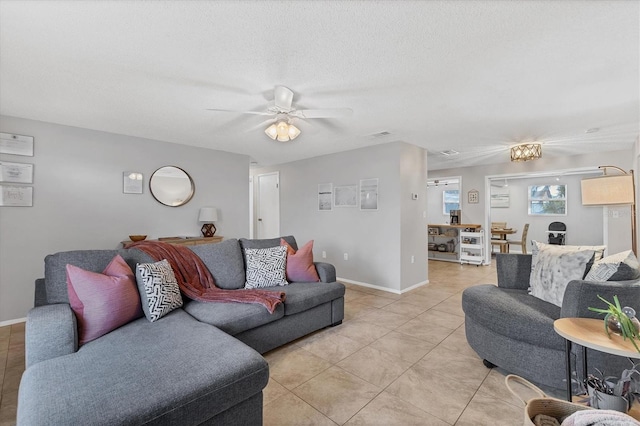 living room featuring light tile patterned floors, a textured ceiling, and ceiling fan