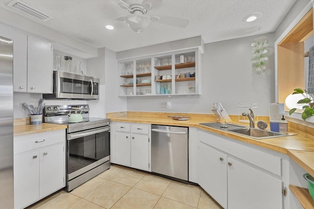 kitchen featuring sink, white cabinets, and appliances with stainless steel finishes