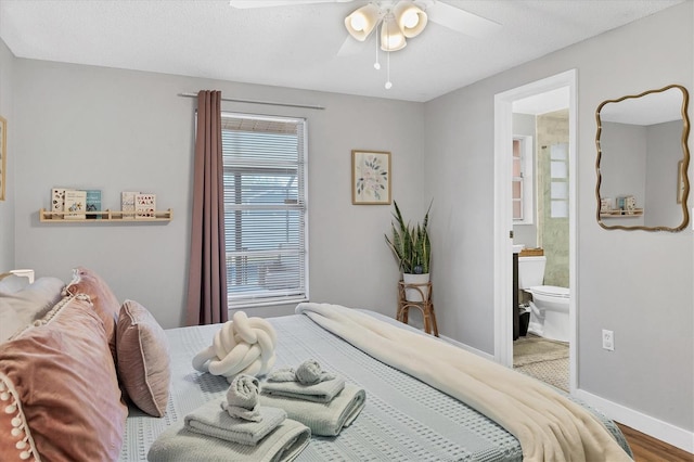 bedroom featuring ensuite bathroom, ceiling fan, and wood-type flooring