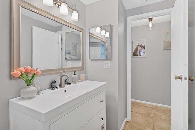 bathroom featuring tile patterned flooring, a textured ceiling, and vanity