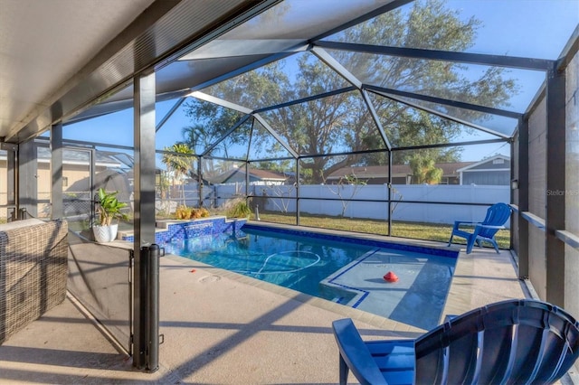 view of swimming pool with glass enclosure and a patio area