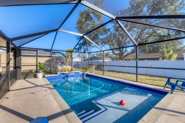 view of swimming pool with a lanai and a patio area