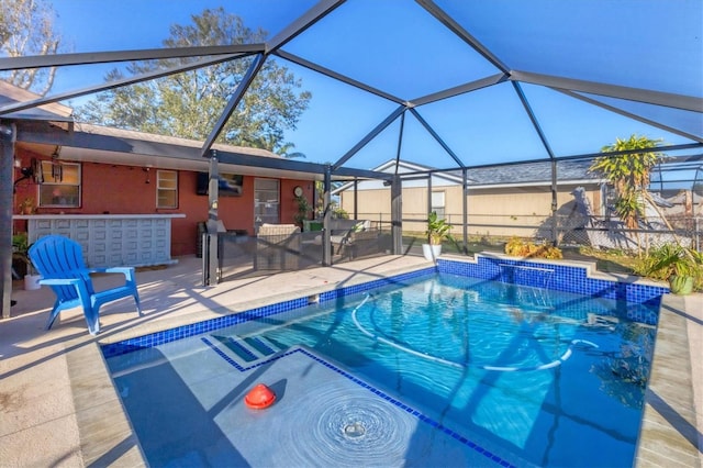 view of pool with a patio area and glass enclosure