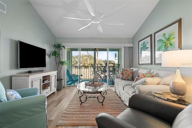 living room featuring ceiling fan, light hardwood / wood-style flooring, and lofted ceiling