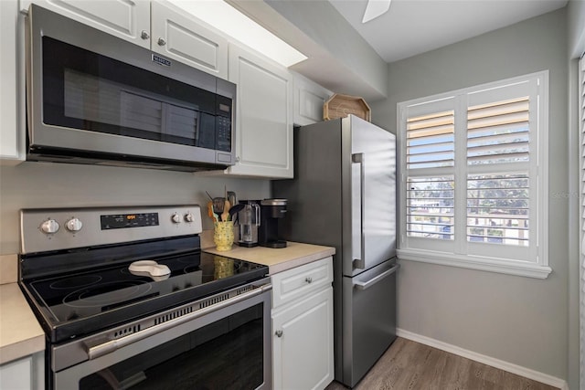 kitchen featuring white cabinetry, hardwood / wood-style floors, and stainless steel appliances